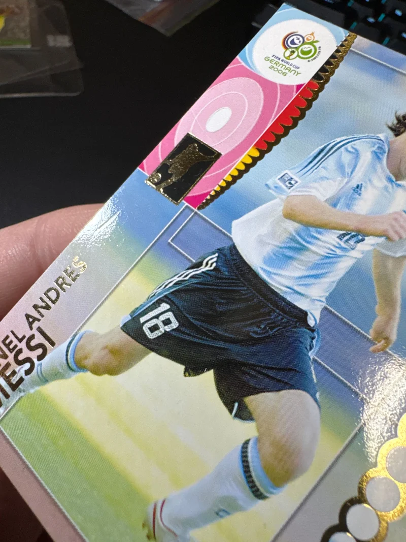 The front of the Lionel Messi Panini 2006 card under angled raking light before the work at CardRevive